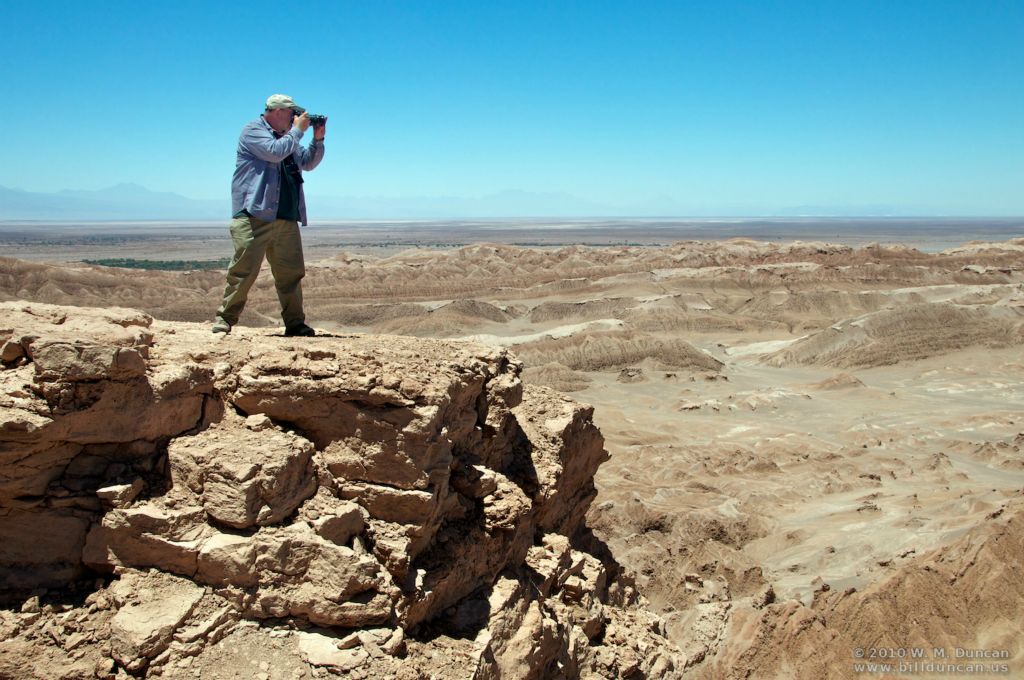 Photographer high up.  Salt flats and Andes beyond.