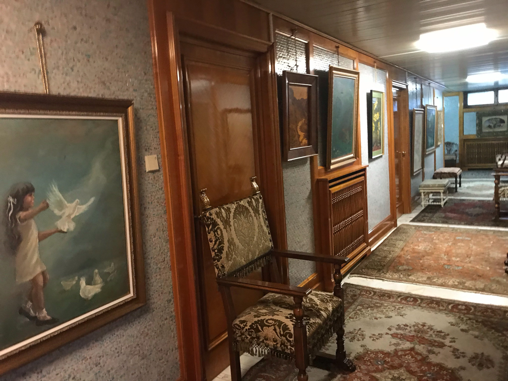 Art hangs on the walls in the corridor of the bomb shelter.
