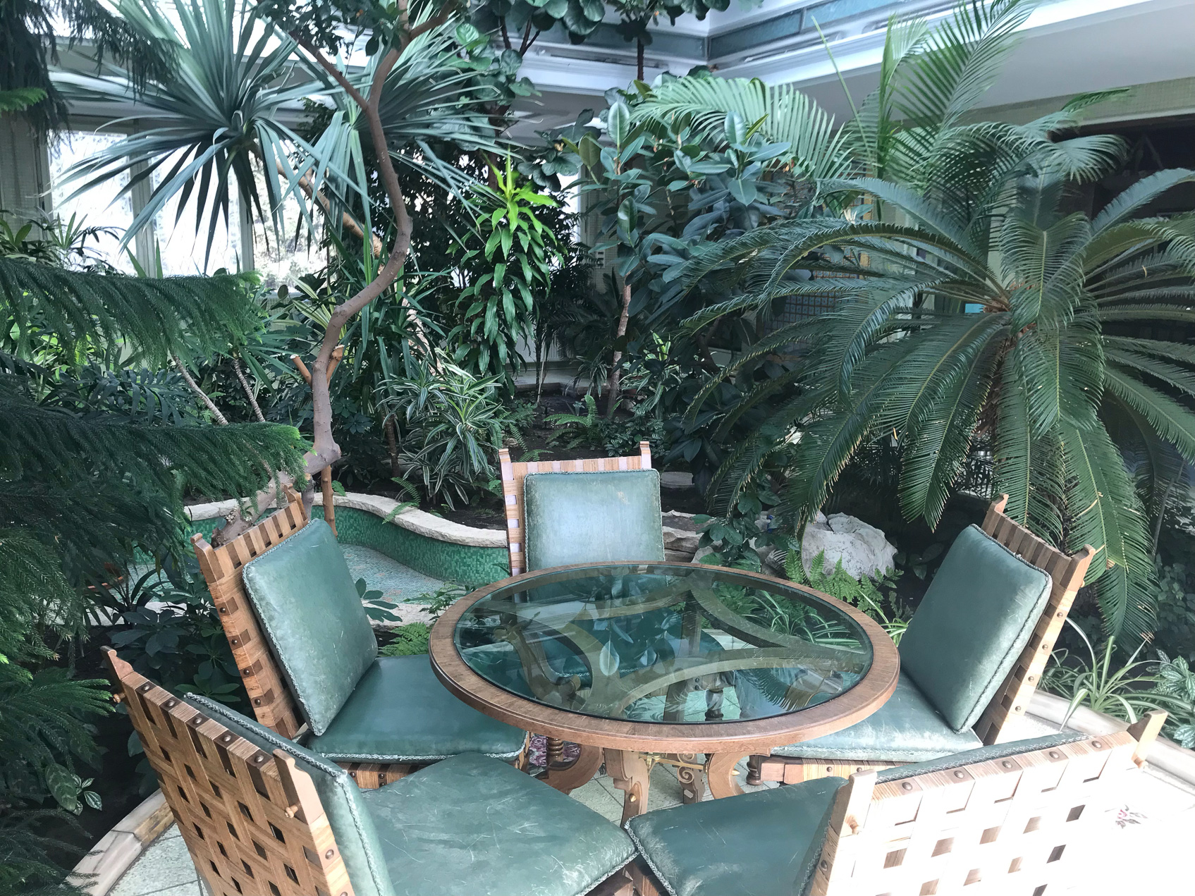 An indoor botantical garden with fountains..
